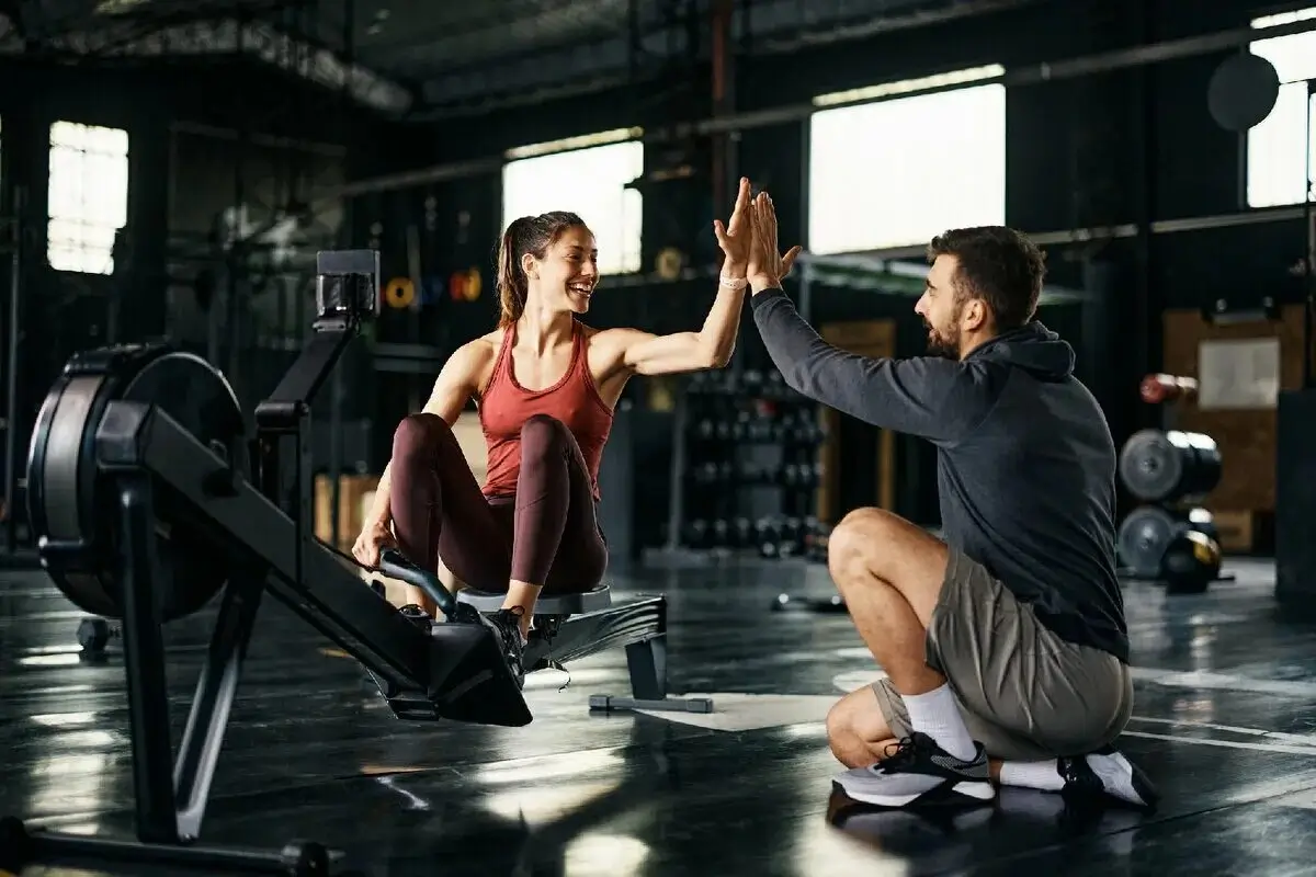 A personal trainer motivating a client during a tough workout