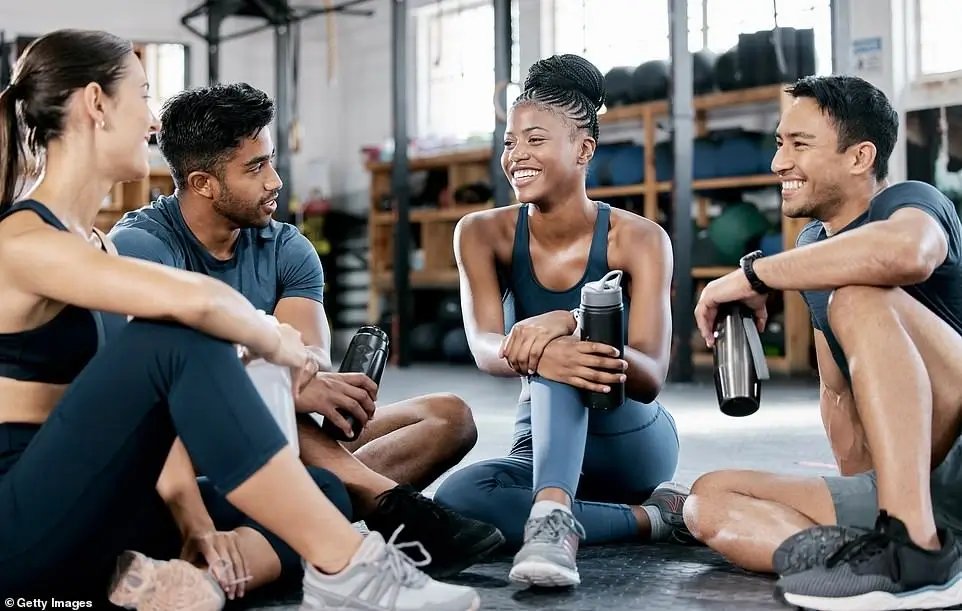 A group of diverse people in a fitness class giving a high-five