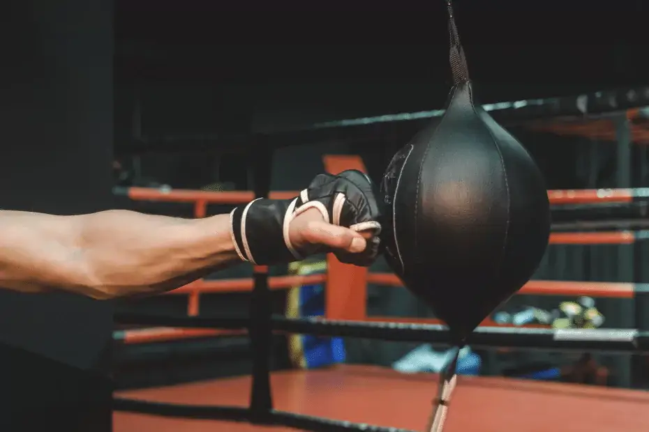 A person training with a punching bag in a boxing class