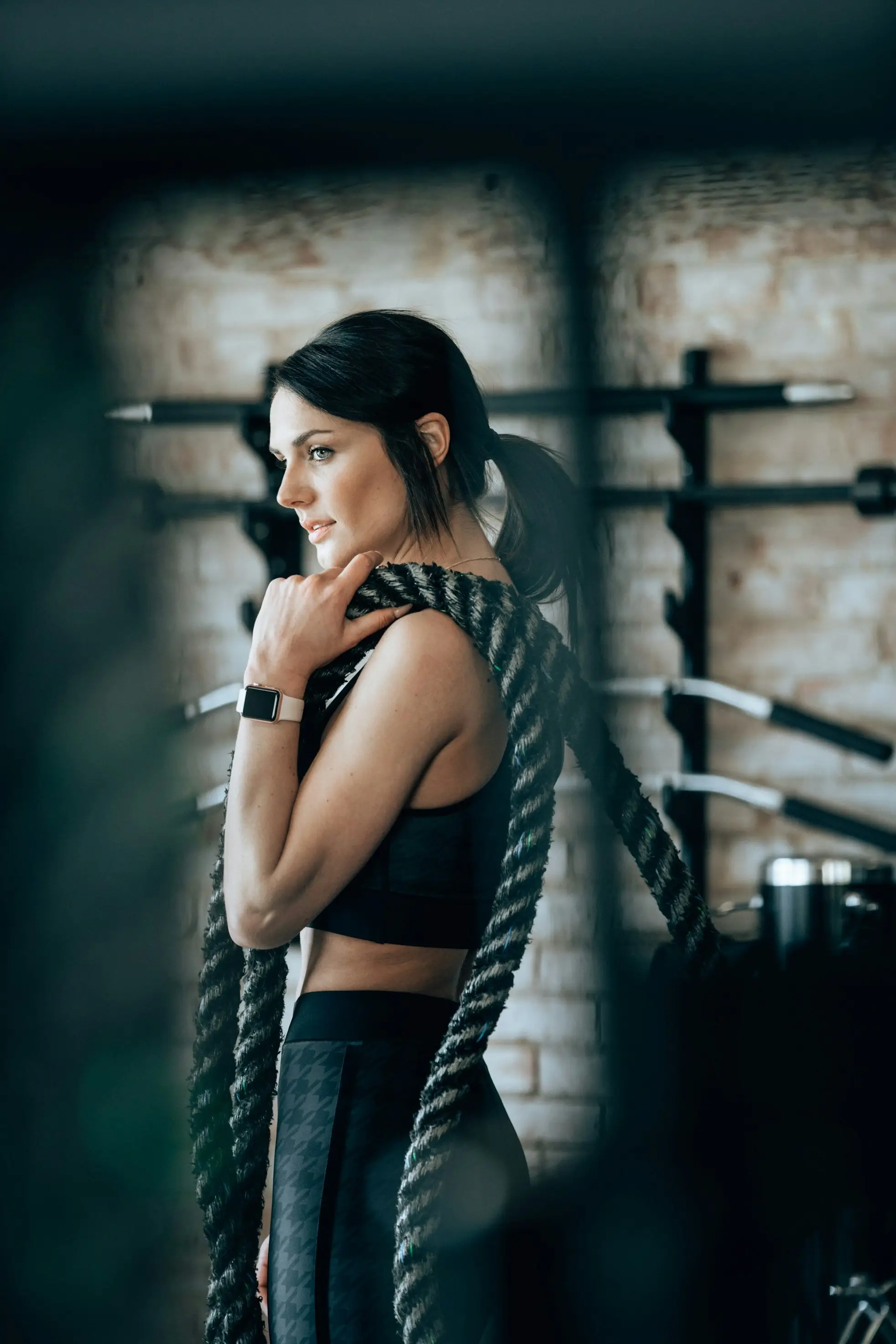 A person looking thoughtfully in a modern gym environment